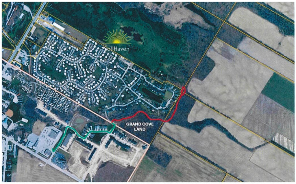 Aerial illustrating proposed connection from subdivision through Grand Cove lands in red, with green being existing walkable neighbourhood access to plaza
